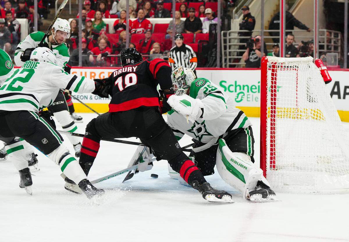 Dallas Stars goaltender Jake Oettinger (29) stops the scoring attempt by Carolina Hurricanes center Jack Drury (18) during the first period at Lenovo Center.