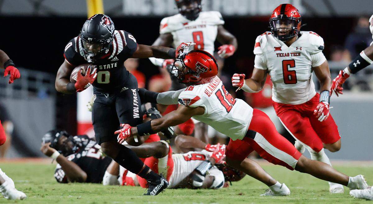 N.C. State running back Demie Sumo-Karngbaye (0) gets past Texas Tech defensive back Keyon Blankenbaker (16) during the second half of N.C. State’s 27-14 victory over Texas Tech at Carter-Finley Stadium in Raleigh, N.C., Saturday, Sept. 17, 2022.