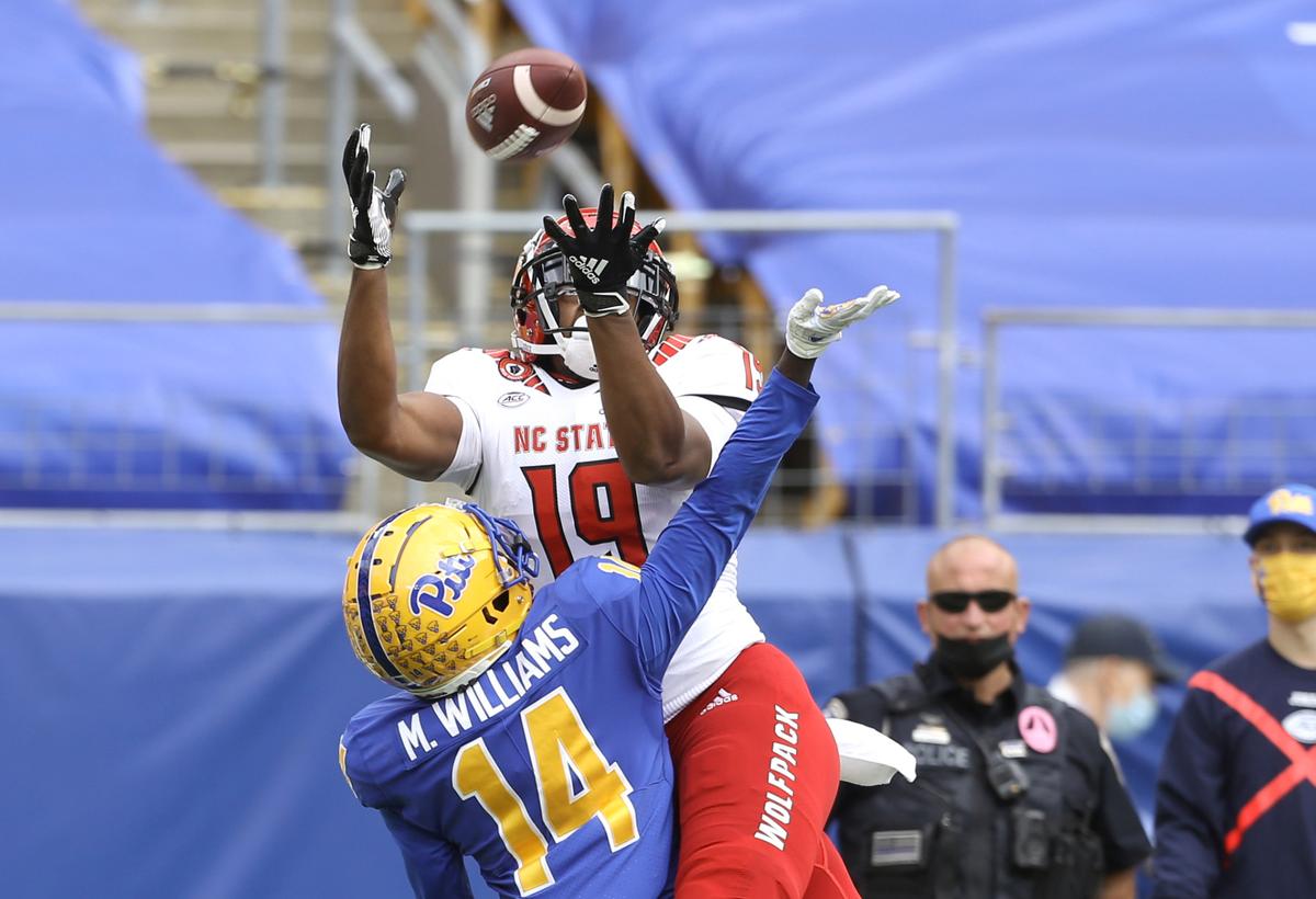 Pittsburgh Panthers defensive back Marquis Williams (14) commits pass interference against N.C. State wide receiver C.J. Riley (19) during the first quarter at Heinz Field.
