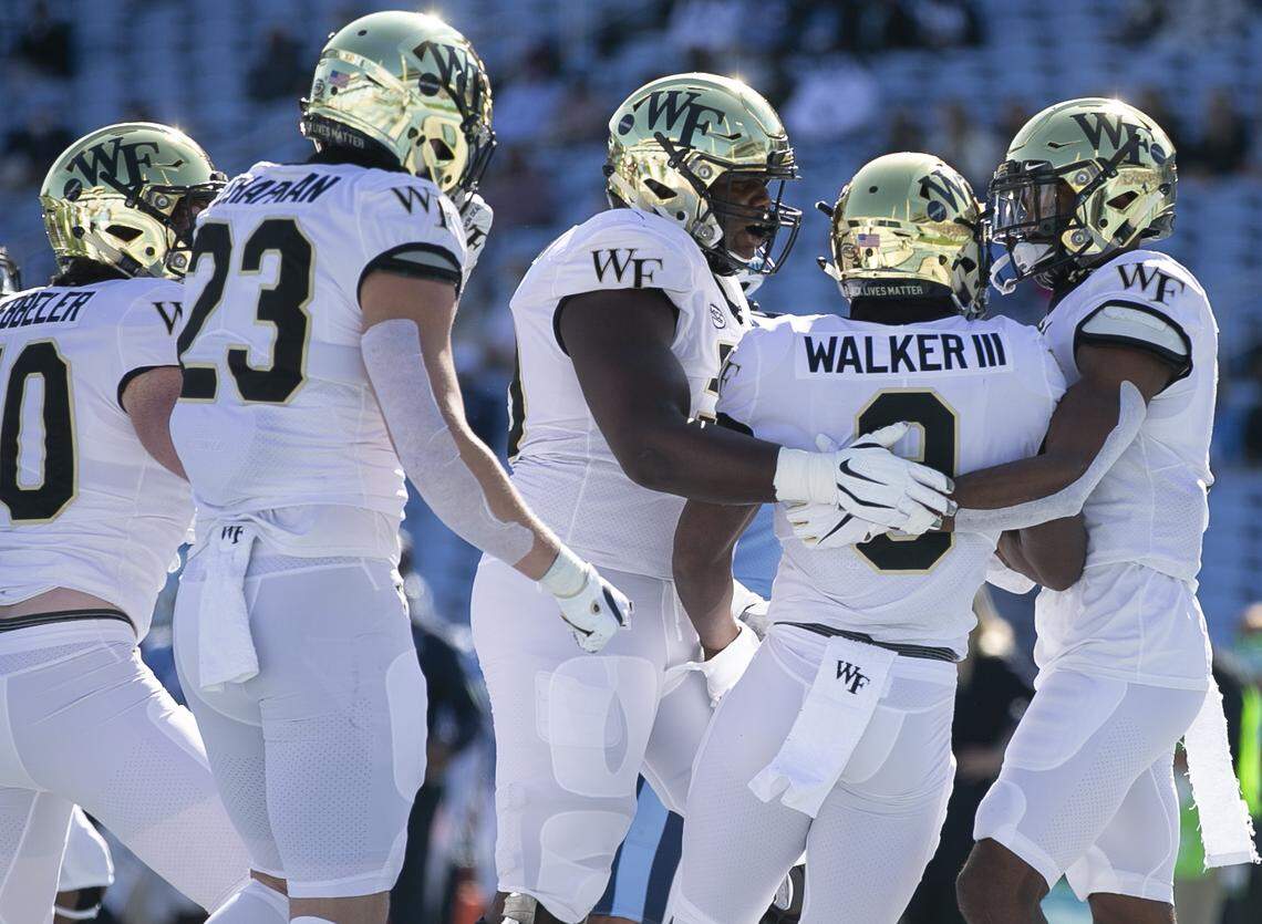 Wake Forest’s Kenneth Walker III (9) celebrates with his teammates after scoring a touchdown in the first quarter to give Wake Forest a 7-0 lead over North Carolina at Kenan Stadium on Saturday, November 14, 2020 in Chapel Hill, N.C.