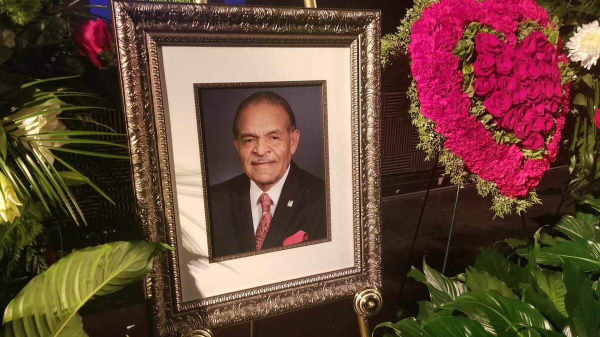 Flowers and plants surround a portrait of Wake County Commissioner James West during his funeral Nov. 27, 2023, at Martin Marietta Center for the Performing Arts.