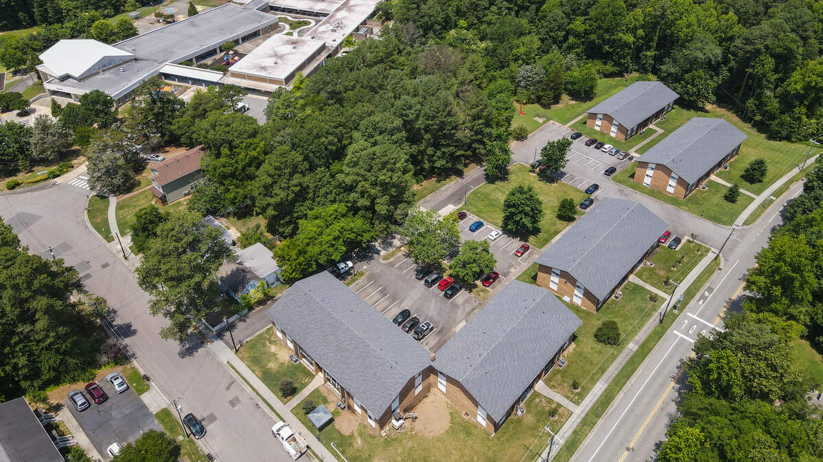 An aerial photo of a 48-unit apartment building and 2.28 acres of nearby land that have recently been sold to Durham Community Land Trustees for affordable housing. The property is located at 1600 Anderson Street in Durham, near the intersection with Chapel Hill Road in the Lakewood Community.