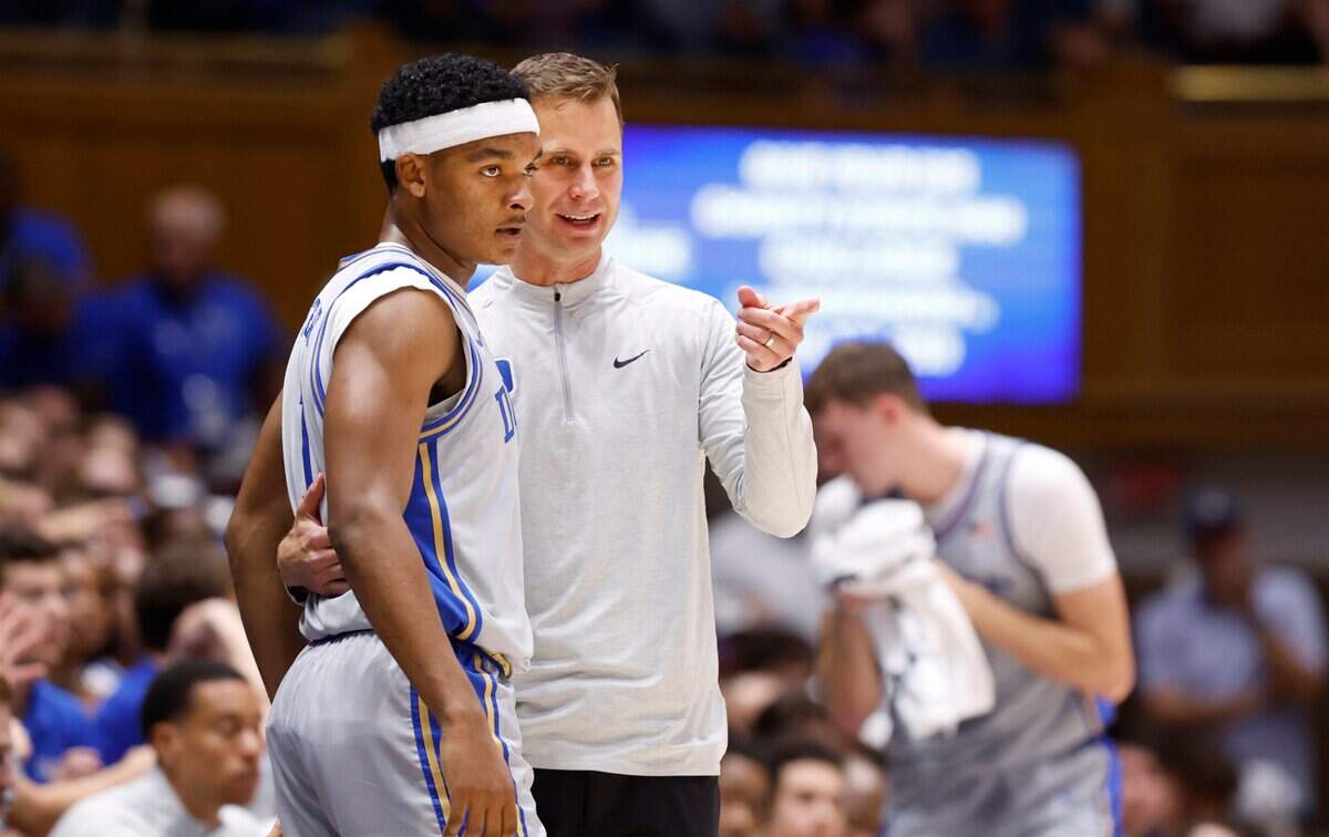 Duke head coach Jon Scheyer talks with Caleb Foster (1) during the first half of Duke’s game against Army at Cameron Indoor Stadium in Durham, N.C., Friday, Nov. 8, 2024.