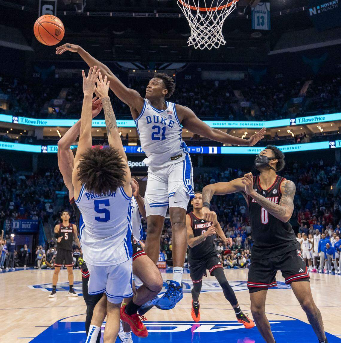 Duke’s Patrick Ngongba II (21) blocks a shot by Louisville’s J’Vonne Hadley (1) in the second half on Saturday, March 15, 2025 during the ACC Tournament Championship at Spectrum Center in Charlotte, N.C.