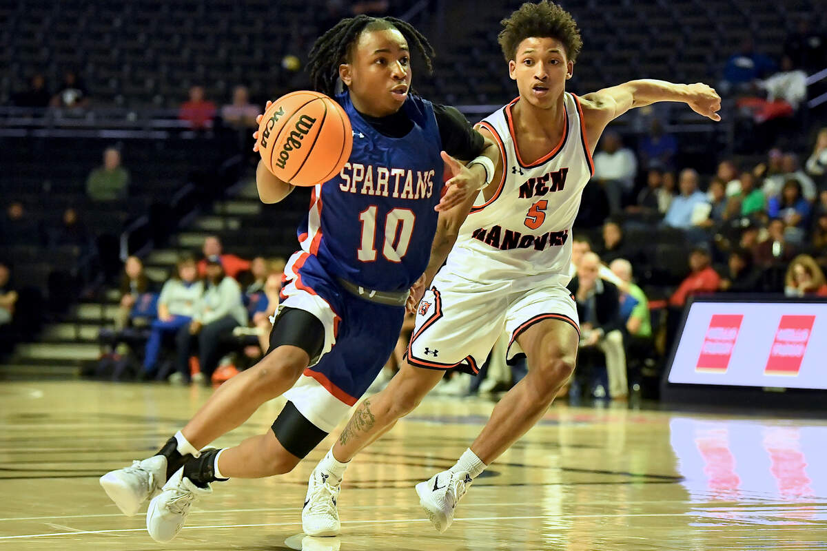Sanderson’s Kendrick Pulley (10) drives to the basket against New Hanover’s Rodmik Allen (5) during the first half. The Sanderson Spartans and the New Hanover Wildcats met in the NCHSAA 4A East Regional Final in Winston-Salem, N.C. on March 12, 2025.