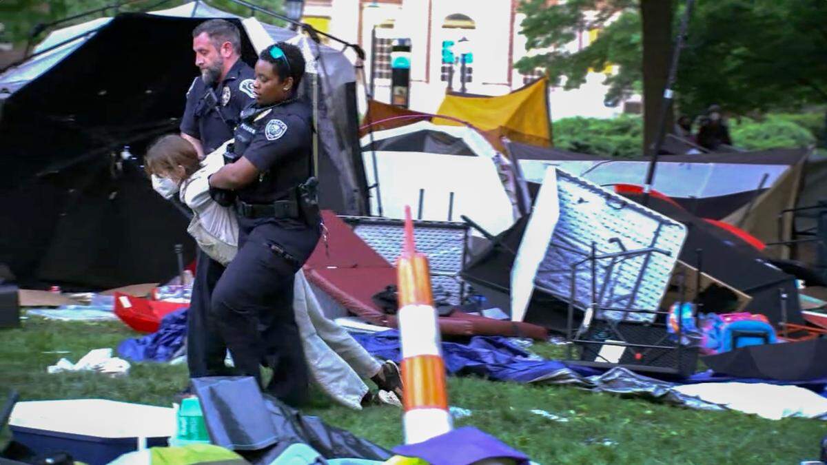 Law enforcement officers move a Pro-Palestinian protester from the encampment on the UNC campus Tuesday morning, April 30, 2024.