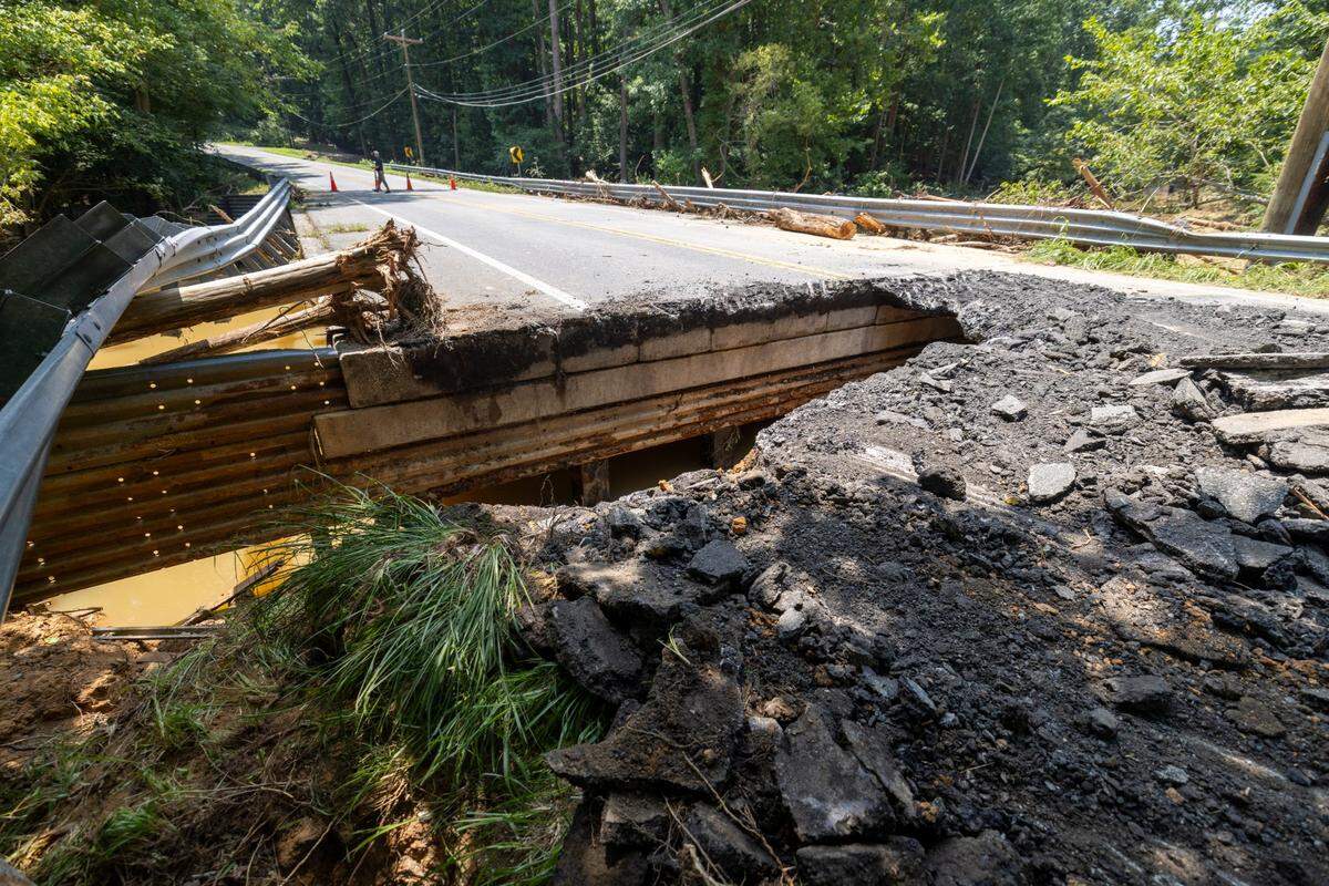 Jones Ferry Road was washed out adjacent to University Lake in Carrboro, N.C., following the remnants of Tropical Storm Chantal, and may remain closed through August, according to the N.C. Department of Transportation. Photo taken Tuesday, July 8, 2025.