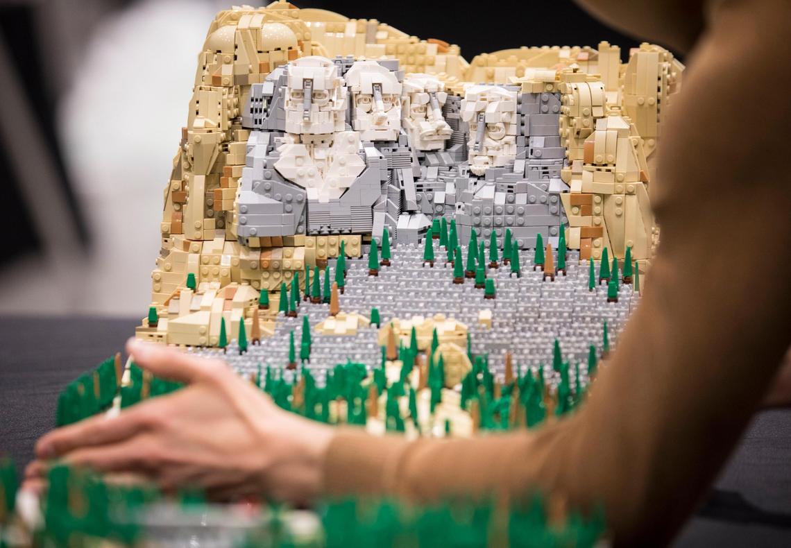 Rocco Buttliere adjusts a finished LEGO version of Mount Rushmore on Friday March 8, 2019 that he built over the course of eight weeks. He brought the piece, and many others, to the Raleigh Convention Center for this weekend’s LEGO fan convention, BrickUniverse.