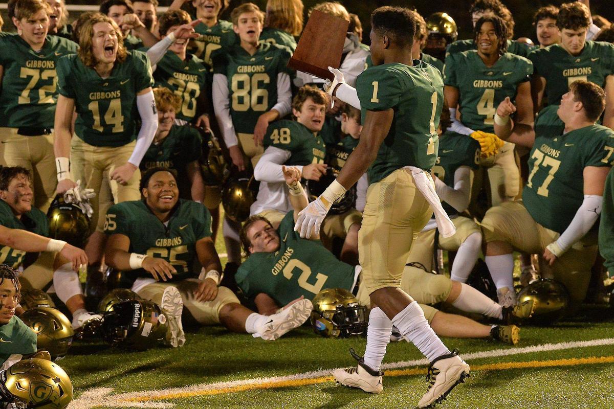 The Cardinal Gibbons football team reacts as Will Mason (1) walks over the East Regional Final trophy after their defeat of Rolesville. The Cardinal Gibbons Crusaders and the Rolesville Rams met in the NCHSAA 4A East Regional Final in Raleigh, N.C. on December 3, 2021