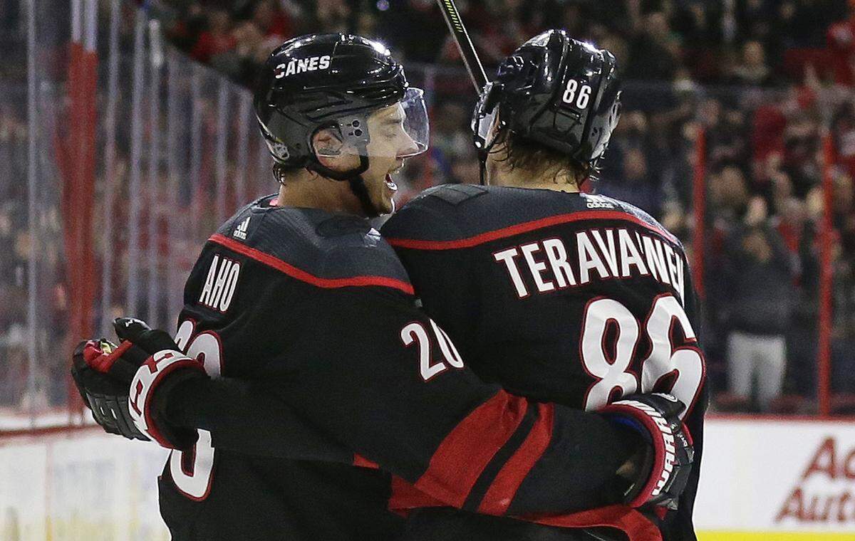 Carolina Hurricanes forward Sebastian Aho (20) celebrates his short-handed goal against the St. Louis Blues with Teuvo Teravainen (86) on Friday.