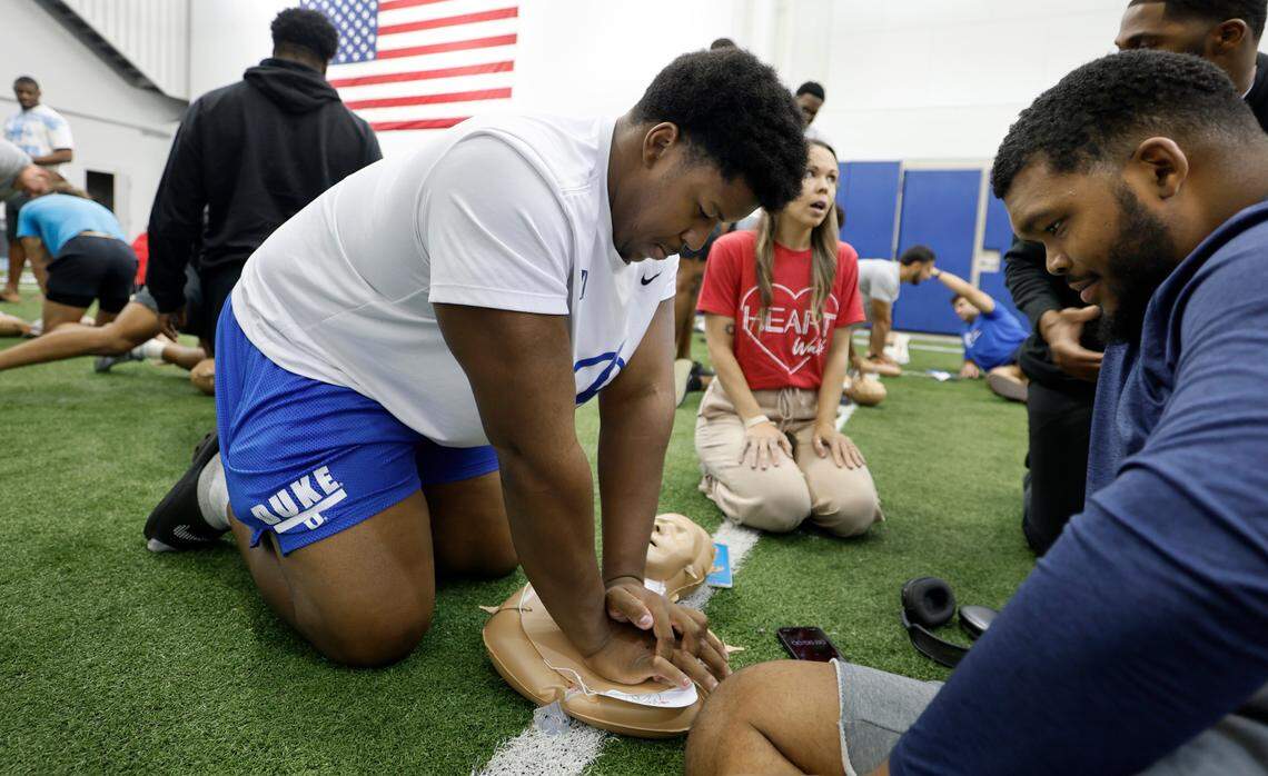 Duke offensive lineman Gemyel Allen, left, and defensive tackle Preston Watson, right, work on CPR training at the Yoh Football Building in Durham, N.C., Tuesday, July 22, 2025. The football team received the CPR training by members of the American Heart Association of the Triangle and Eastern North Carolina.