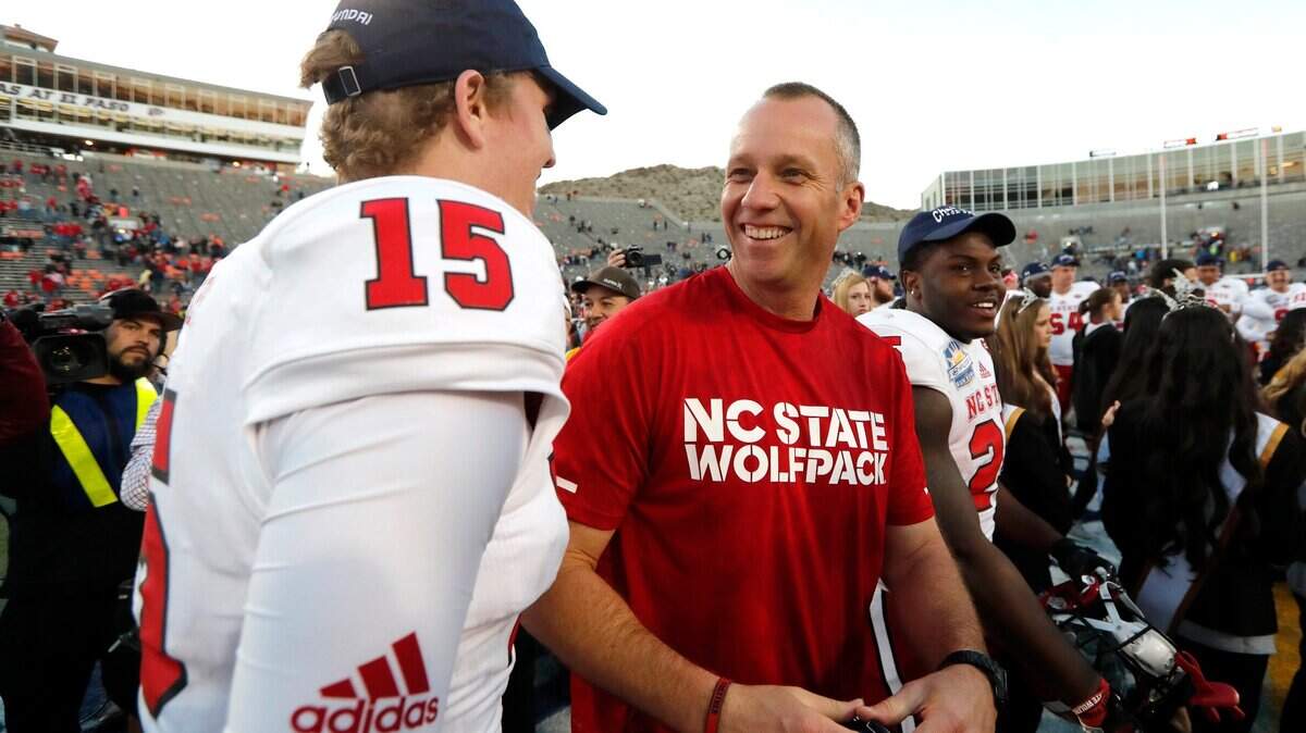 N.C. State coach Dave Doeren laughs with quarterback Ryan Finley (15) after the Wolfpack’s 52-31 victory over Arizona State in the Hyundai Sun Bowl at Sun Bowl Stadium in El Paso, TX Friday, Dec. 29, 2017.