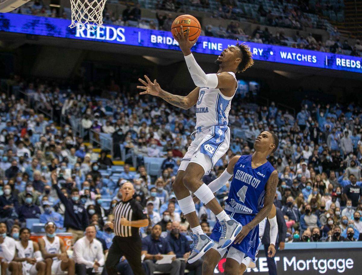 North Carolina’s Anthony Harris (0) breaks to the basket on a fast break ahead of Elizabeth City State’s Charles Page (4) during the second half on Friday, November 5, 2021 at the Smith Center in Chapel Hill, N.C.