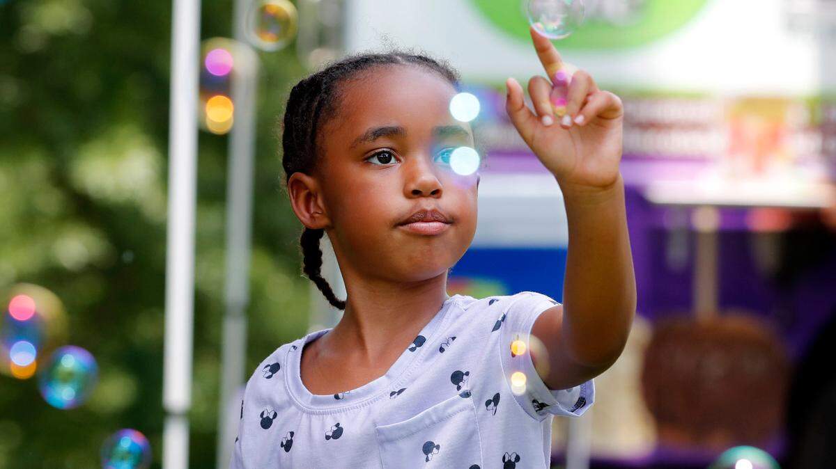 Maliah Bazzell, 6, of Knightdale plays with bubbles during the 2021 Capital City Juneteenth Celebration at Dorothea Dix Park in Raleigh on June 19, 2021.