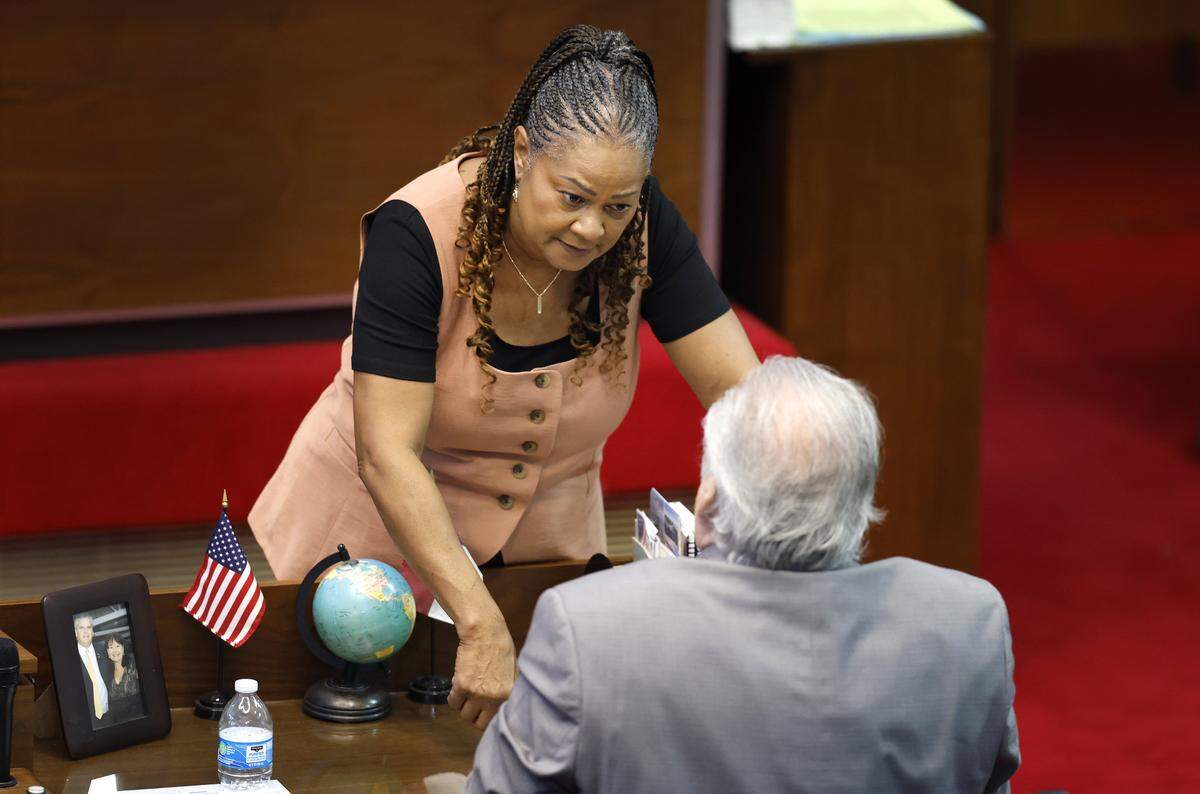 State Rep. Carla Cunningham talks with State Rep. John Torbett during a break in the N.C. House session at the Legislative Building in Raleigh, N.C., Tuesday, July 29, 2025.