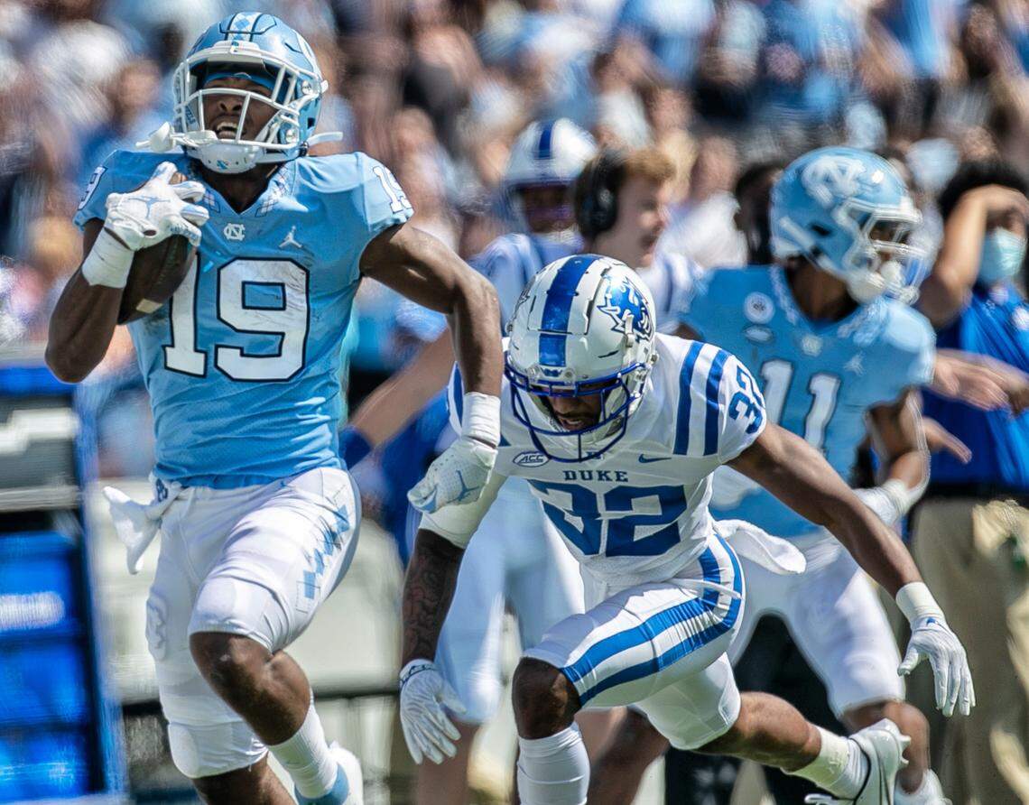 North Carolina’s Ty Chandler (29) romps past Duke’s Jalen Alexander (32) for a 75-yard touchdown on a pass from quarterback Sam Howell (7) in the first quarter on Saturday, October 2, 2021 at Kenan Stadium in Chapel Hill, N.C.