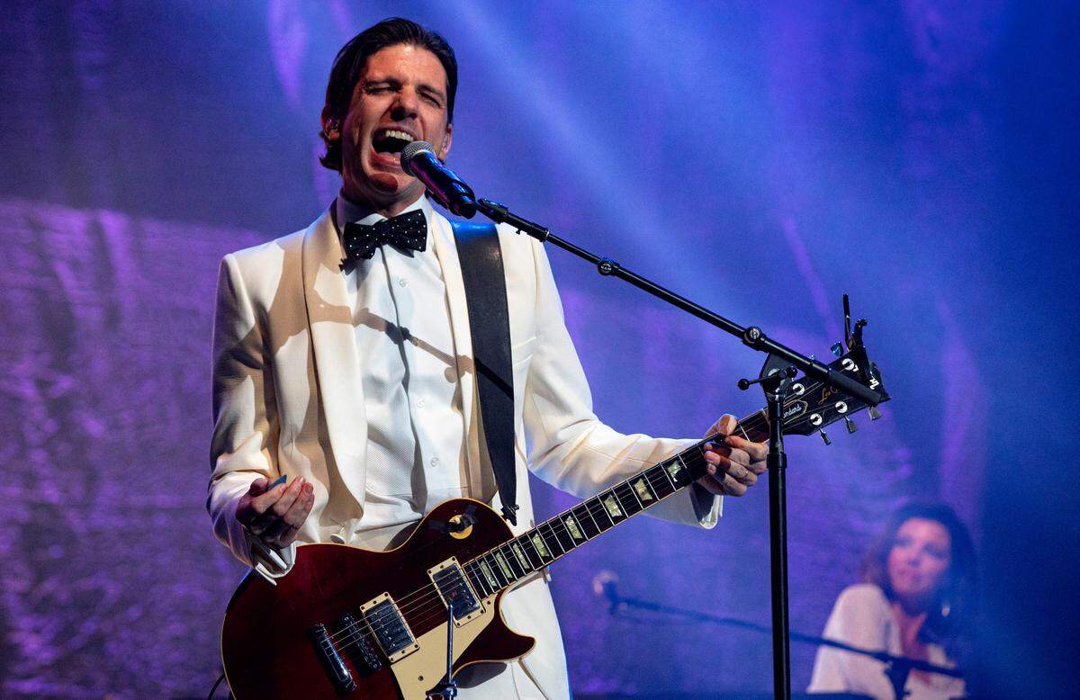 Seth Avett sings lead vocals on “Bleeding White” as The Avett Brothers play Raleigh’s PNC Arena for their annual New Year’s Eve show, Dec. 31, 2023.