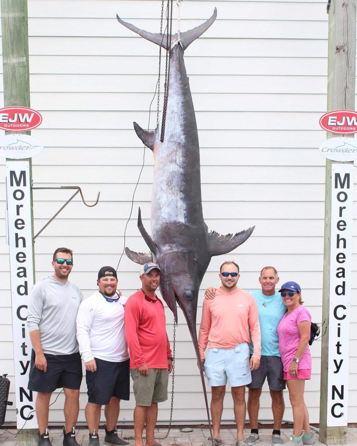 Cary Carney of Newport, NC, poses with the state-record swordfish he caught on his son Brandon Carney’s boat off Morehead City in August.