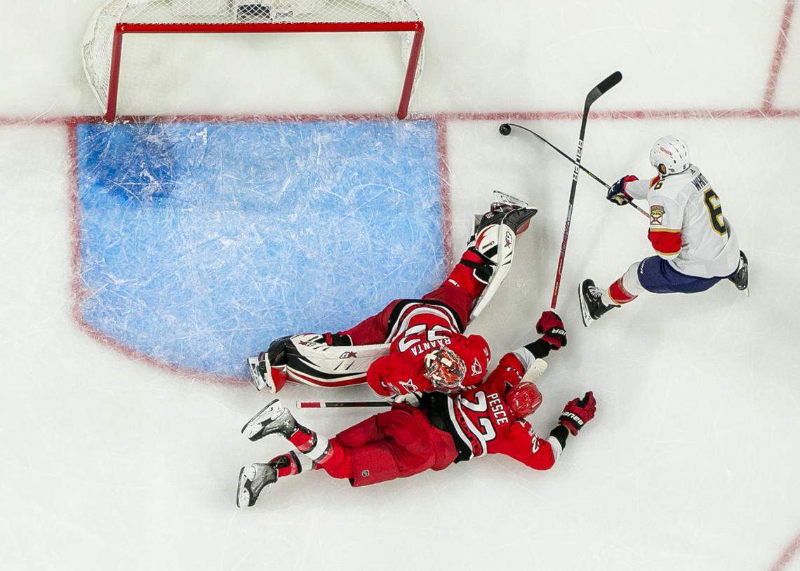 The Florida Panthers Colin White (6) works against Carolina Hurricanes goalie Antii Raanta (32) and Brett Pesce (22) in the third period during Game 2 of the Eastern Conference Finals on Saturday, May 20, 2023 at PNC Arena in Raleigh, N.C.