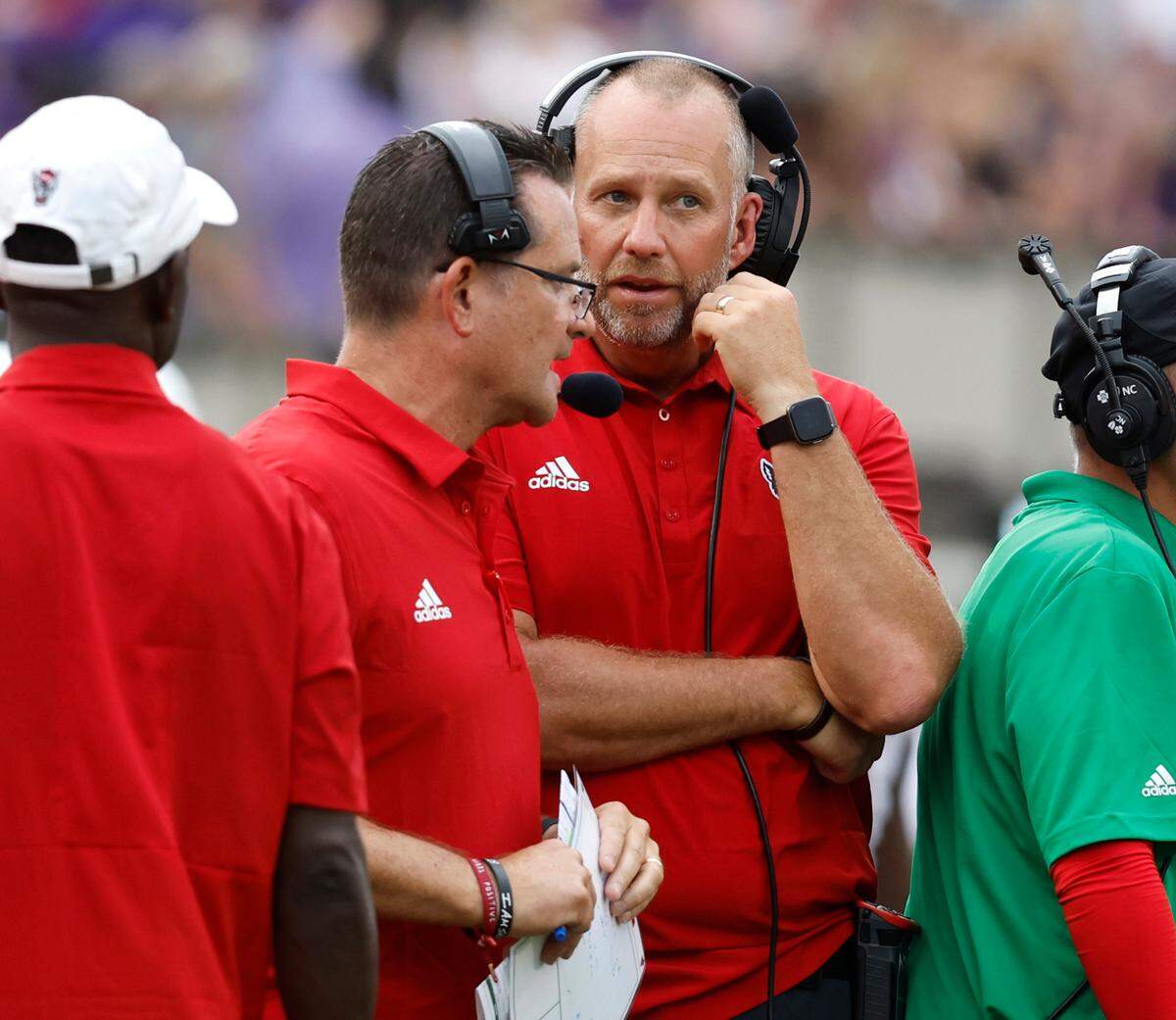 N.C. State head coach Dave Doeren talks with offensive coordinator Tim Beck during the second half of N.C. State’s 21-20 victory over ECU at Dowdy-Ficklen Stadium in Greenville, N.C., Saturday, Sept. 3, 2022.