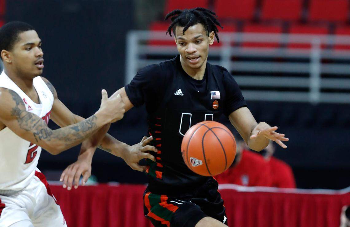Miami’s Isaiah Wong (2) takes the ball up court after it was stolen as N.C. State’s Shakeel Moore (2) trails during the second half of Miami’s 64-59 victory over N.C. State at PNC Arena in Raleigh, N.C., Saturday, January 9, 2021.