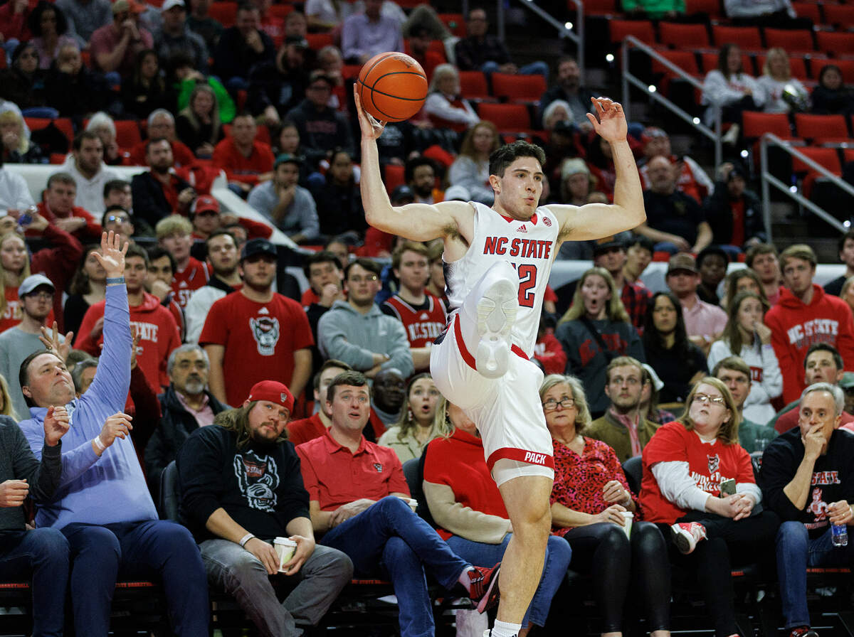 N.C. State’s Michael O’Connell attempts to save a ball from going out of bounds during the second half of the Wolfpack’s 74-68 win over Miami on Tuesday, Jan. 30, 2024, at PNC Arena in Raleigh, N.C.