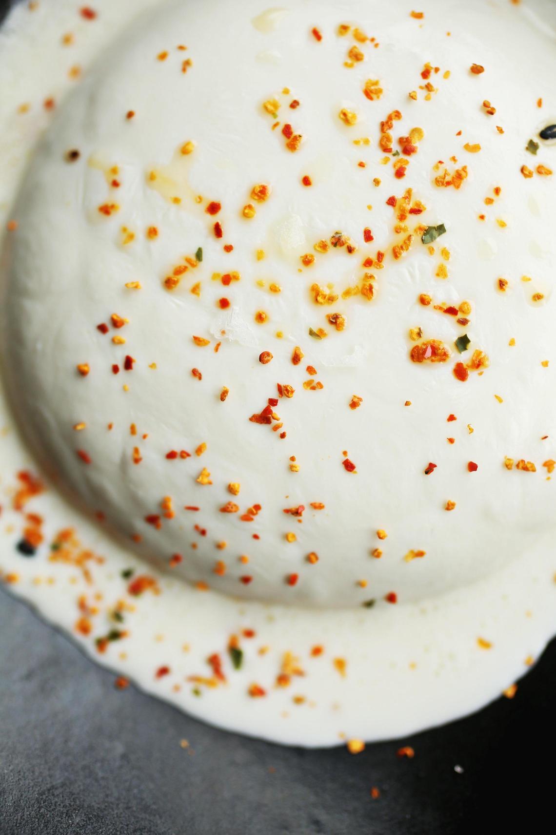 Fresh pulled mozzarella is served with kombu garlic bread, shiso and togarashi at Italian-Japanese fusion restaurant Papa Shogun in Raleigh.