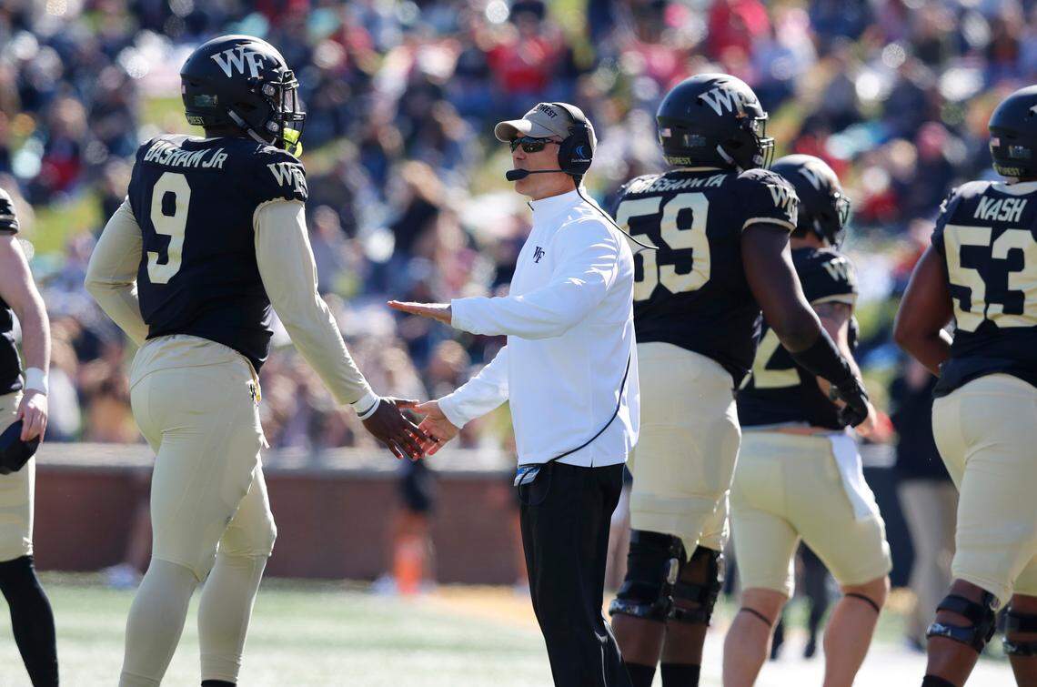 Wake Forest head coach Dave Clawson congratulates his team including Carlos Basham Jr. (9) during the first half of N.C. State’s game against Wake Forest at BB&T Field in Winston-Salem, N.C., Saturday, Nov. 2, 2019.