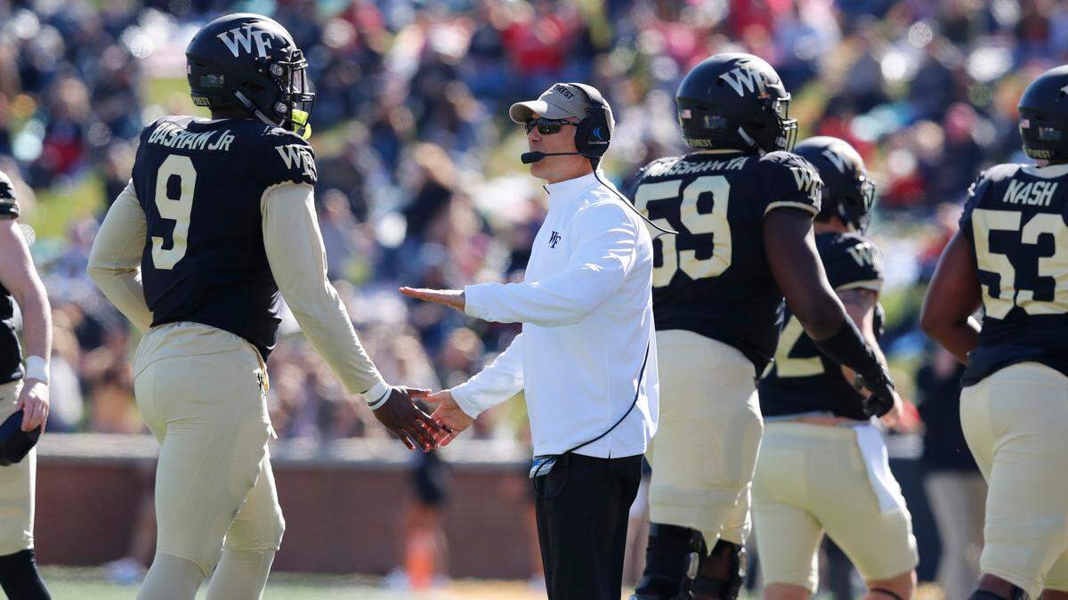 Wake Forest head coach Dave Clawson congratulates his team including Carlos Basham Jr. (9) during the first half of N.C. State’s game against Wake Forest at BB&T Field in Winston-Salem, N.C., Saturday, Nov. 2, 2019.