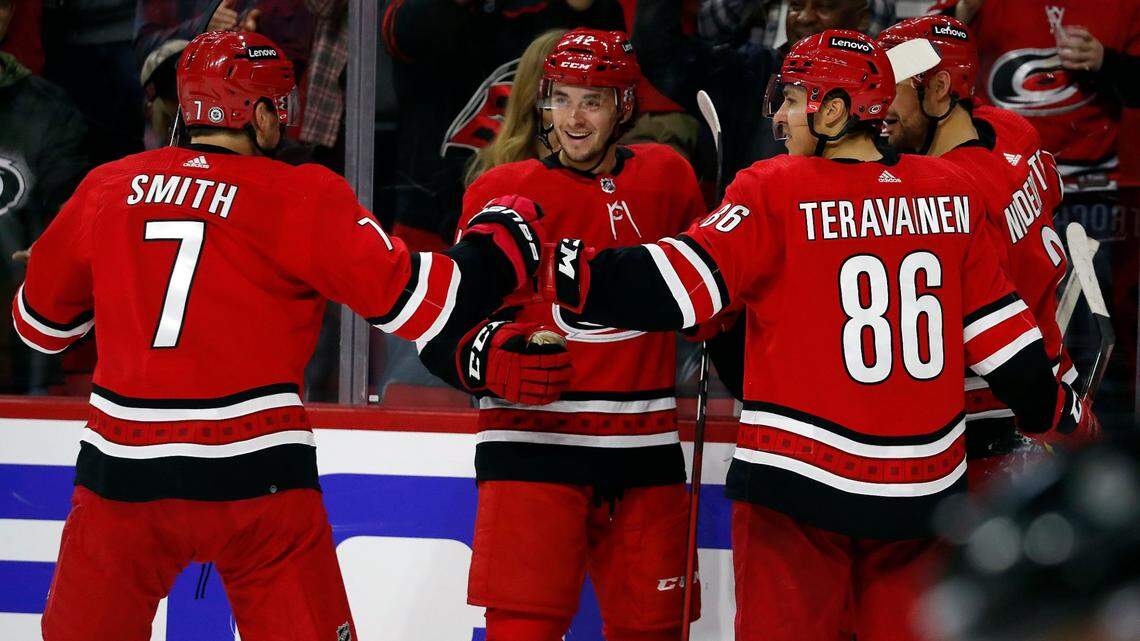 Carolina Hurricanes’ Teuvo Teravainen (86) celebrates his goal with teammates Brendan Smith (7), Maxime Lajoie (42) and Nino Niederreiter (21) during the second period of an NHL hockey game against the Buffalo Sabres in Raleigh, N.C., Saturday, Dec. 4, 2021. (AP Photo/Karl B DeBlaker)