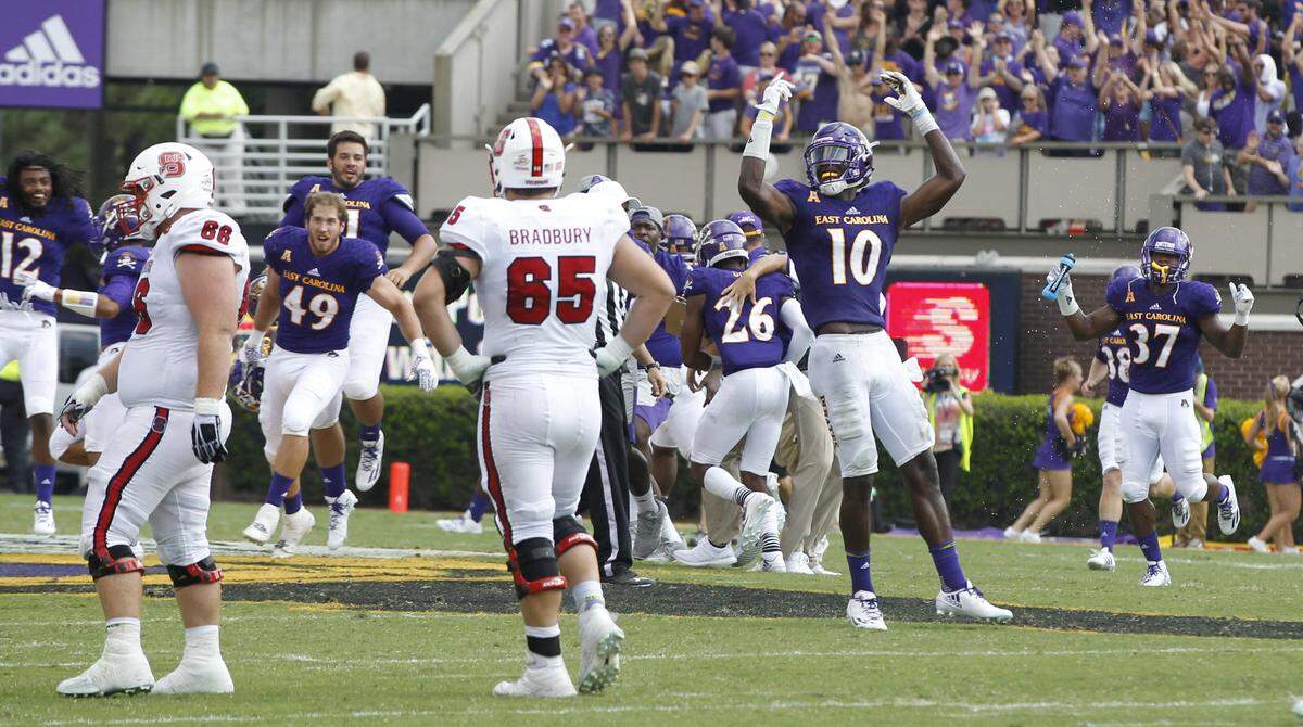 East Carolina players, including Yiannis Bowden (10), celebrate as time runs out in the game during ECU’s 33-30 victory over N.C. State at Dowdy-Ficklen Stadium in Greenville, N.C., Saturday, Sept. 10. 2016.