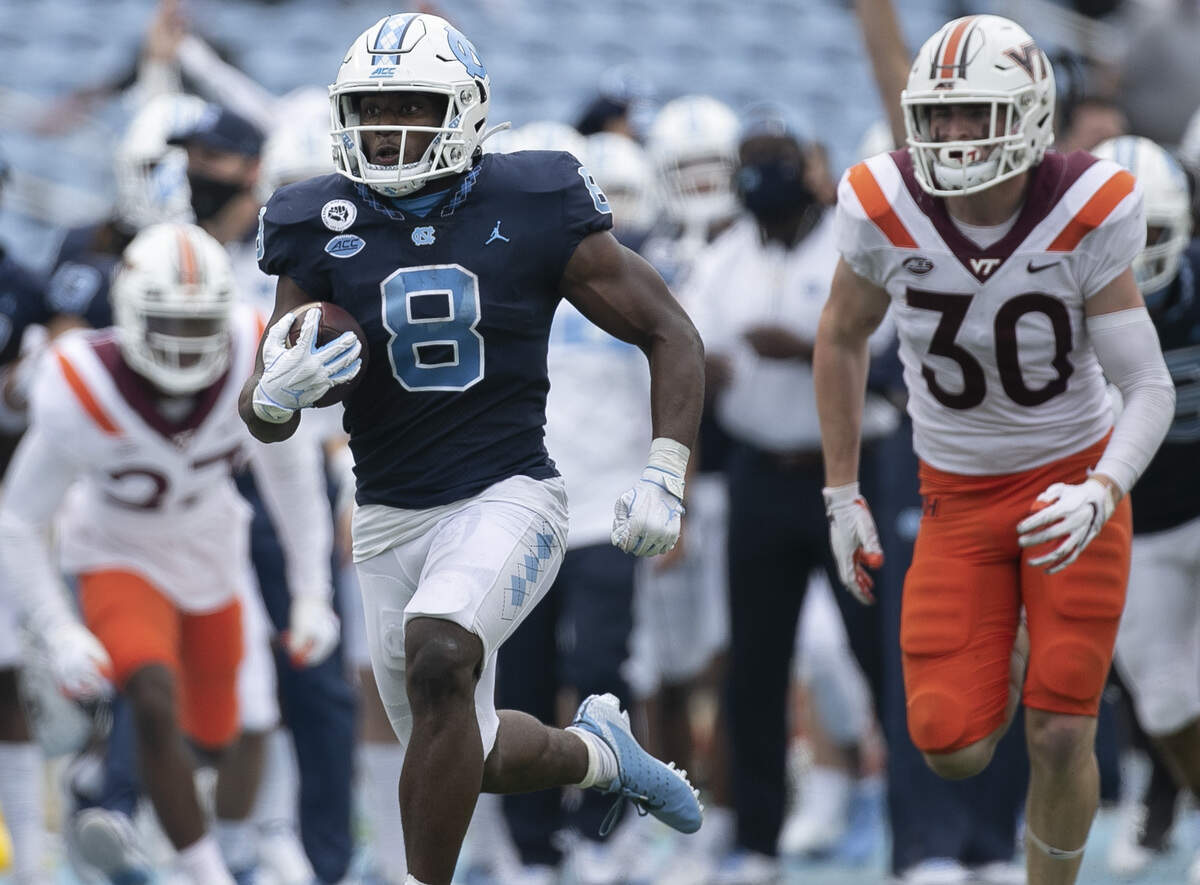 North Carolina’s Michael Carter (8) breaks away from Virginia Tech’s Tyler Matheny (30) for a 62-yard touchdown in the fourth quarter on Saturday, October 10, 2020 at Kenan Stadium in Chapel Hill, N.C.