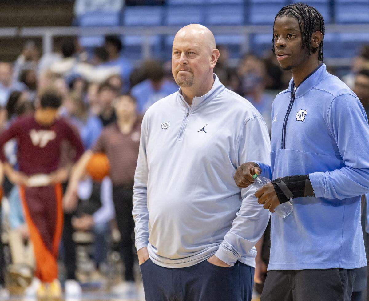 North Carolina forward Caleb Wilson talks with assistant coach Pat Sullivan prior to the Tar Heels’ game against Virginia Tech on Saturday, February 28, 2026 at the Smith Center in Chapel Hill, N.C. Wilson is recovering from an injury to his left hand. 