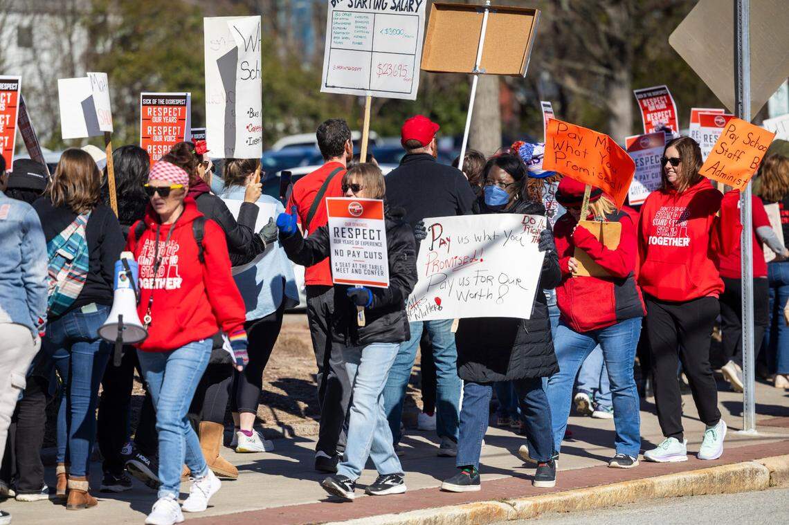 Durham County Public Schools staff, parents and community members rally and picket outside DPS’s Fuller Building in downtown Durham Monday, Feb. 5, 2024. Salary issues have plunged the district into chaos. The issues stem from an accounting error that resulted in administration withdrawing raises promised to 1,300 school staff, prompting protests and strikes since mid-January.