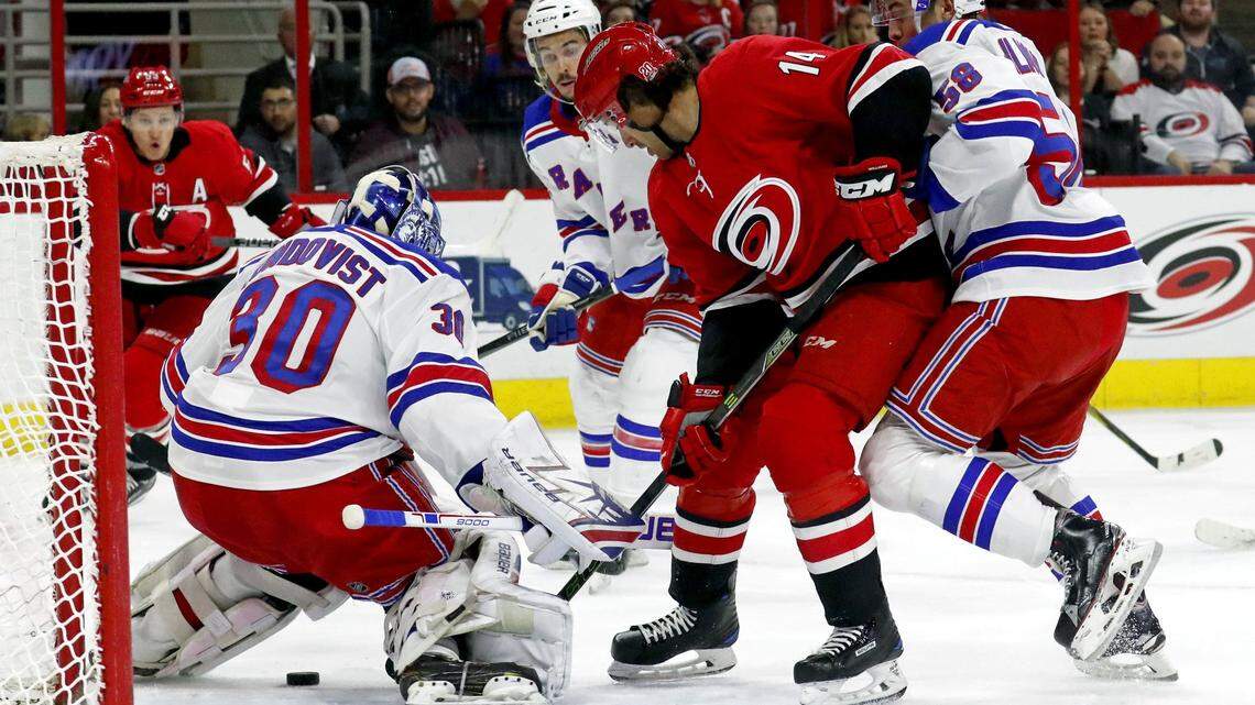 The Canes’ Justin Williams (14) can’t get the puck past the Rangers’ Henrik Lundqvist (30) and John Gilmour (58) during the first period. The Rangers beat the Canes 2-1..