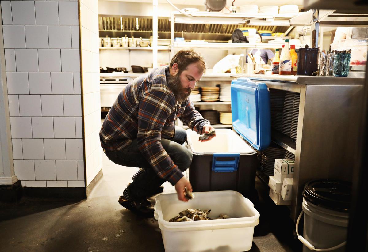 Saint James owner and chef Matt Kelly pulls oysters from a cooler on Jan. 8, 2020, that he plans to serve at the “Friends with Benefits” dinner at St. Roch in Raleigh the next night. The restaurant plans to reopen on Jan. 23, 2020, after being closed for several months after the Durham gas explosion last April.
