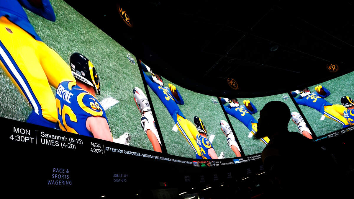FILE - In this Feb. 3, 2019, file photo, a man watches Super Bowl LIII at the Westgate Superbook sports book in Las Vegas. (AP Photo/John Locher)