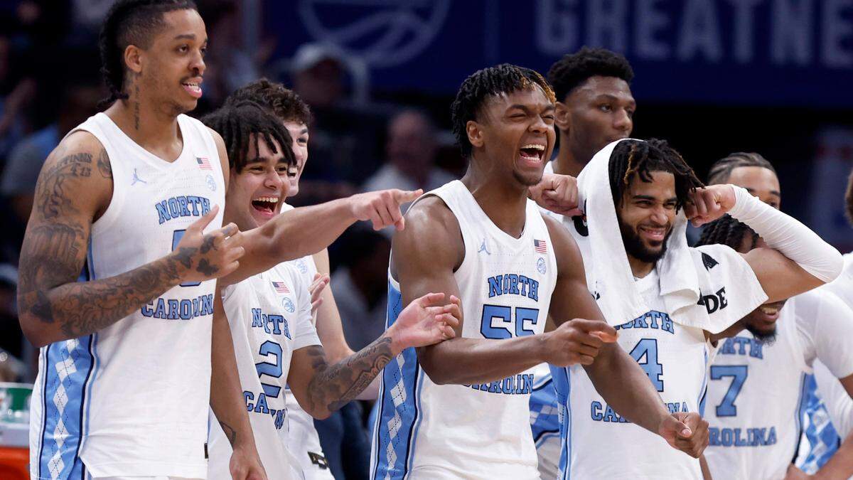 North Carolina players, from left, Armando Bacot (5), Elliot Cadeau (2), Harrison Ingram (55), RJ Davis (4) and the rest of the bench celebrate during second half of UNC’s 92-67 victory over Florida State in the quarterfinal round of the 2024 ACC Men’s Basketball Tournament at Capital One Arena in Washington, D.C., Thursday, March 14, 2024.