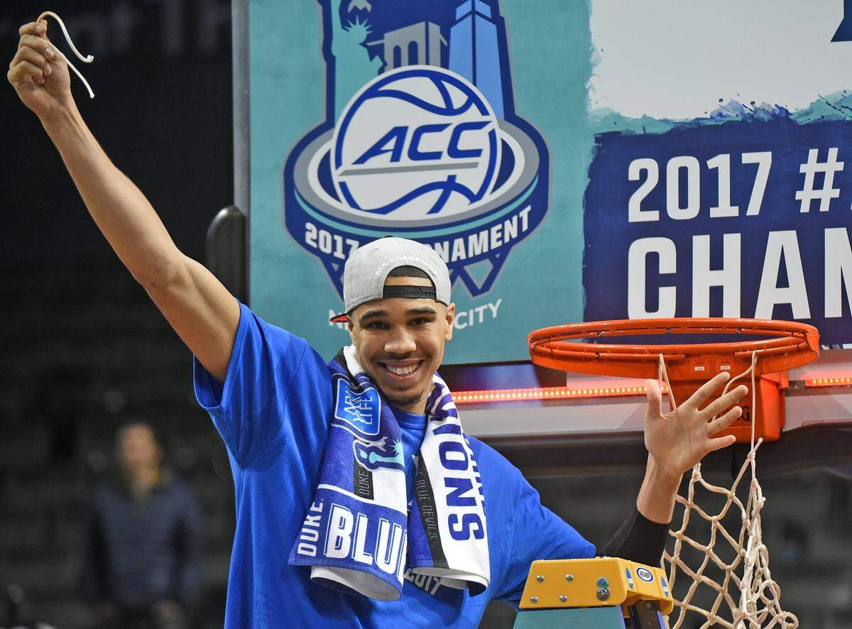 Duke forward Jayson Tatum (0) helps cut down the nets after the Blue Devils beat Notre Dame to 75-69 to win the 2017 ACC Men's Basketball Tournament at the Barclays Center in Brooklyn, N.Y. Saturday, March 11, 2017