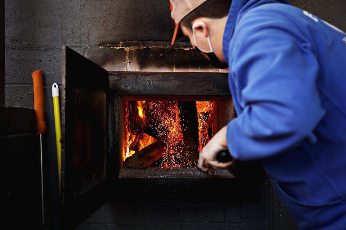 Sam Jones BBQ smokehouse manager Rich Pettitt works in the smokehouse in the new downtown Raleigh location on Wednesday morning, Feb. 3, 2021. The restaurant is starting off with a soft-open this week.