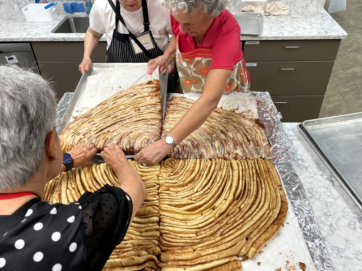 The 3-foot diameter and roughly 35 pound cinnamon roll was baked in four parts and assembled in the SECU Family House kitchen on Friday, Oct. 4, 2024, in honor of National Cinnamon Roll Day.