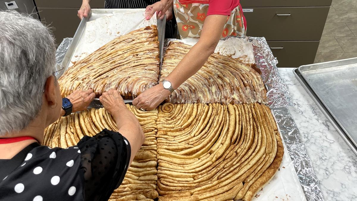 The 3-foot diameter and roughly 35 pound cinnamon roll was baked in four parts and assembled in the SECU Family House kitchen on Friday, Oct. 4, 2024, in honor of National Cinnamon Roll Day.