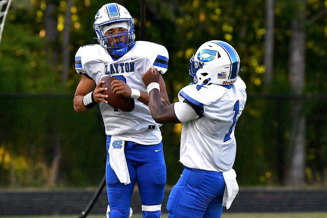 Clayton quarterback 	Aiden Smalls (2) celebrates the touchdown in the end zone with running back Noah Smith (1) during the first half. The Wake Forest Cougars and the Clayton Comet met in a non-conference football game in Wake Forest, N.C. on August 23, 2024.