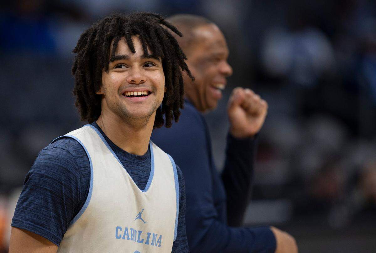 North Carolina’s Elliot Cadeau (2) smiles after an exchange with coach Hubert Davis during their practice on Wednesday, March 20, 2024 as they prepare for the NCAA Tournament at Spectrum Center in Charlotte, N.C.
