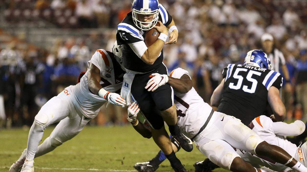 Duke quarterback Chris Katrenick (15) scores on a 9-yard touchdown run past Virginia Tech defender Alan Tisdale (34) and Jaylen Griffin (41) in the fourth quarter of an NCAA college football game, Friday, Sept. 27, 2019, in Blacksburg, Va.