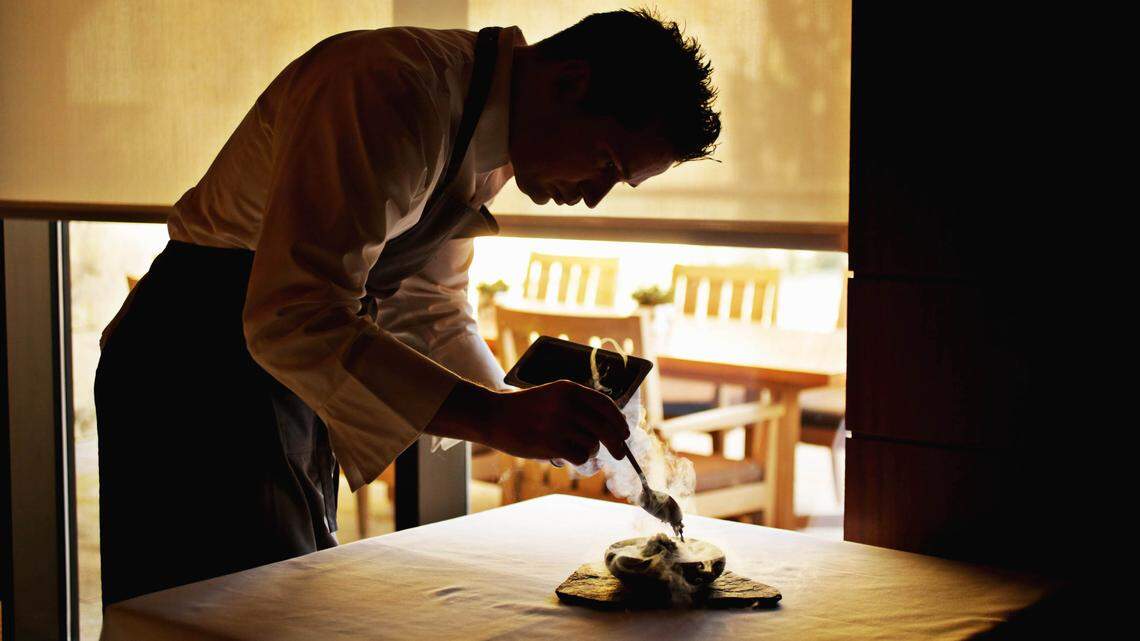 Herons’ executive chef Steven Devereaux Greene adds the finishing touches to the beet dish in the Cary restaurant’s private dining room Jan. 15, 2019.