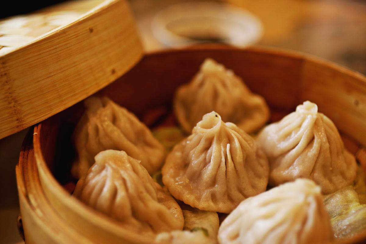 Steam rises off the steamed Shanghai tiny buns — pinch-topped purses of dumpling with a soupy minced pork and vegetable filling — at Yi Ge Asian Cuisine in Clayton.