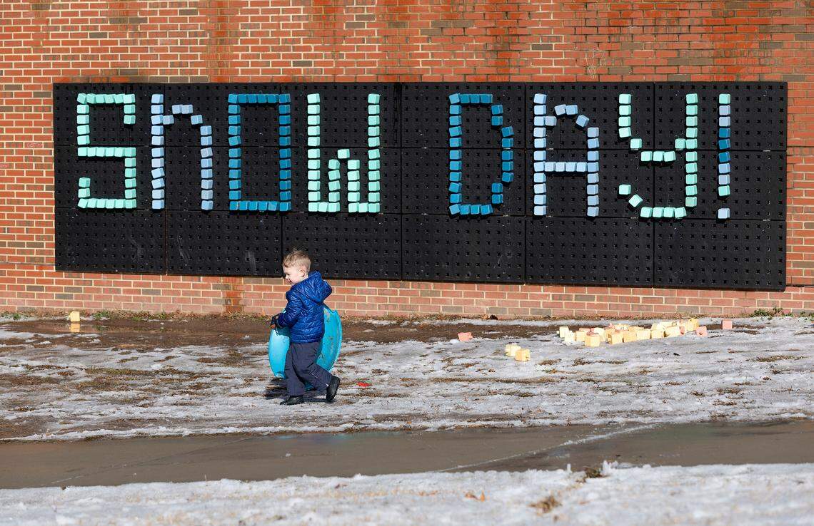 Will Cotter, 4, walks by a sign in Durham Central Park while sledding with his family on Saturday, Jan. 11, 2025.