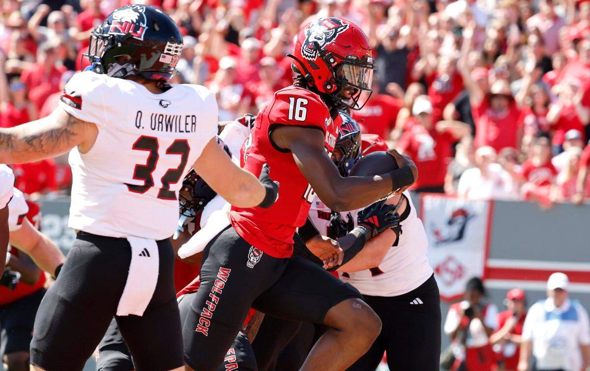 N.C. State quarterback CJ Bailey (16) runs for a one-yard touchdown during the first half of N.C. State’s game against Northern Illinois at Carter-Finley Stadium in Raleigh, N.C., Saturday, Sept. 28, 2024.