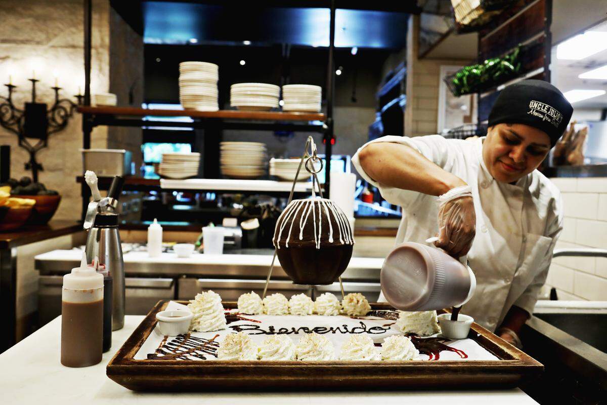 Uncle Julio’s trainer Yesenia Chinchilla makes the restaurant’s Chocolate Lover’s Pinata. Dessert and entertainment in one, this showstopper features a chocolate shell, suspended from a metal frame. Break the shell open with the provided wooden dowel, and a shower of chocolate empanada bites, miniature churros, and fresh strawberries come tumbling out.